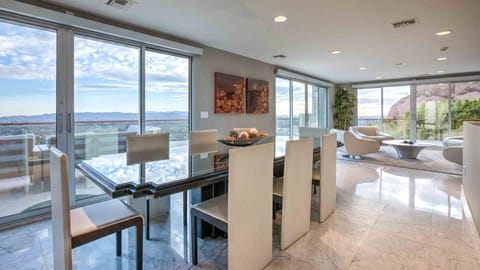 Formal dining room seating 8 people w/ multiple sliding doors to outdoor patio