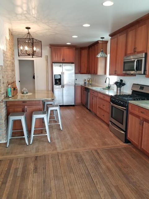 The kitchen is fully stocked with cooking utensils, pots/pans, spices, etc