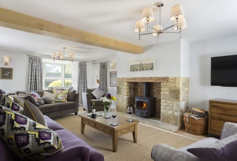 Ground floor: Spacious sitting room with wood burning stove