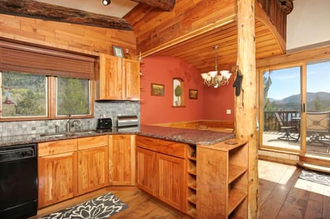 Full kitchen on top level with granite countertops and stainless steel appliances.