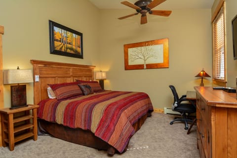 Master bedroom with king bed,  desk/chair, dresser, remote fan, large closet