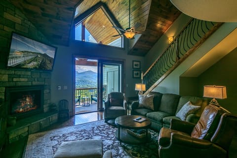Vaulted living area with breathtaking year round views, gas fireplace, & 55" TV.