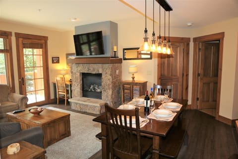 Living room with stone fireplace and 50" HDTV.