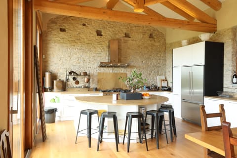 The island with bar seating, power outlets, and sink in the large open kitchen