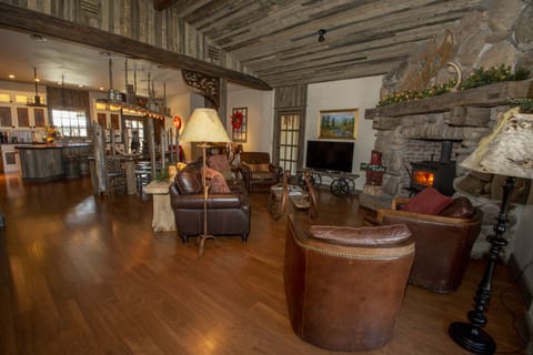 Cozy living room with wood burning stove and custom river rock wall