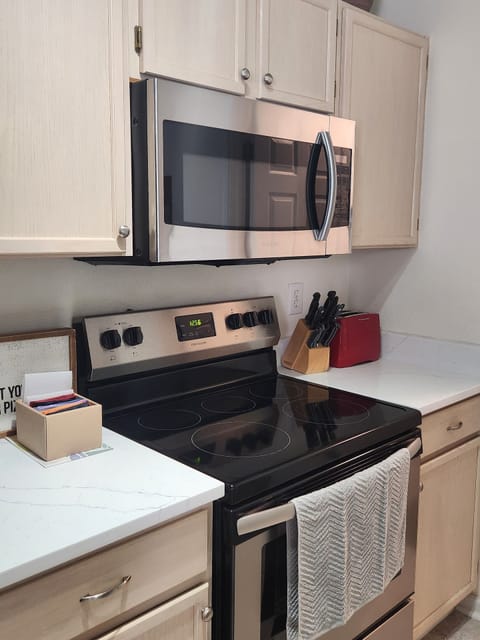 Kitchen range, microwave, and oven.
