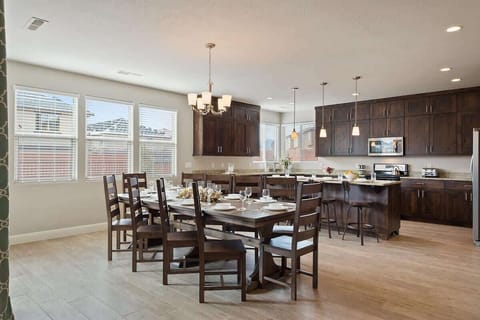 Large open concept kitchen with dining table for 10 and bar
