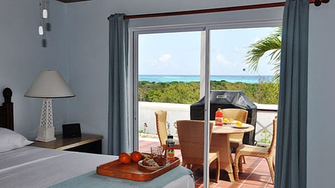 Master bedroom with spectacular ocean view, overlooking expansive balcony.