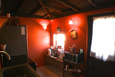 Kitchen with full size fridge, microwave, oven/stove, grill