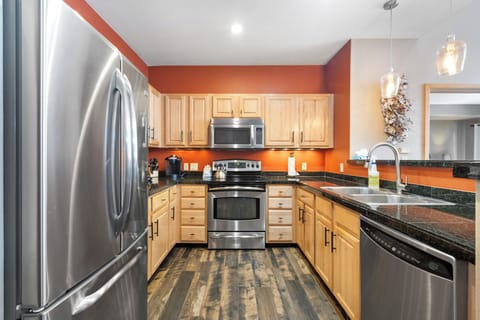 Kitchen featuring stainless steel appliances and breakfast bar.