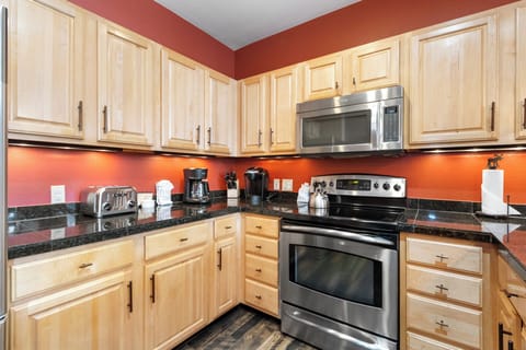 Kitchen featuring stainless steel appliances and breakfast bar.