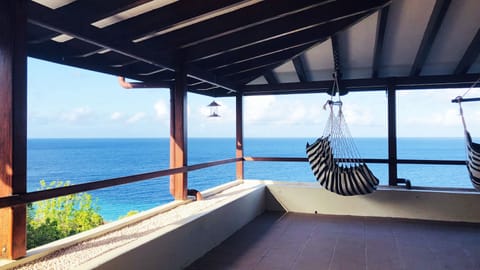 Relax and enjoy a panoramic view of the Caribbean Sea from our covered terrace.