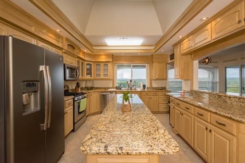 Upstairs kitchen.  Window looks out to pool area and canyons. Cool skylight too!
