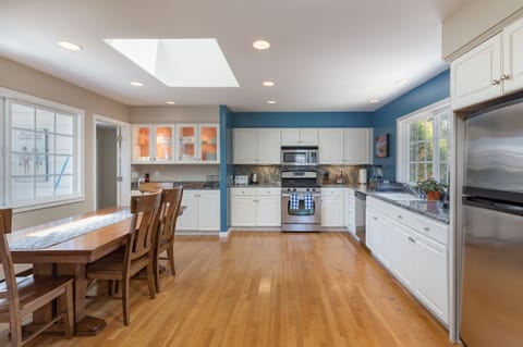 Fully stocked open kitchen and dining area.