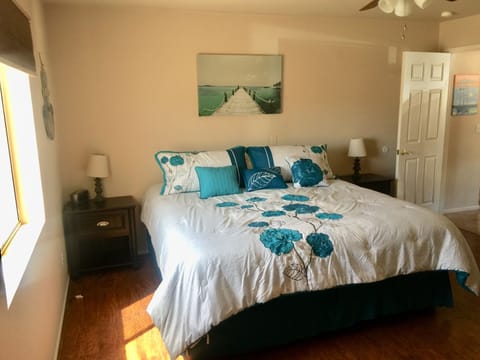 Master bedroom has hardwood flooring with king size bed, walk-in closet, & bath.
