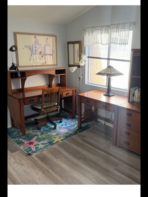 Office with ample workspace and daybed