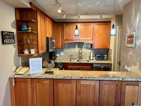 Remodeled kitchen with Cherry Wood Cabinets and Granite Counters