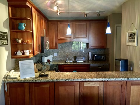 Remodeled kitchen with Cherry Wood Cabinets and Granite Counters