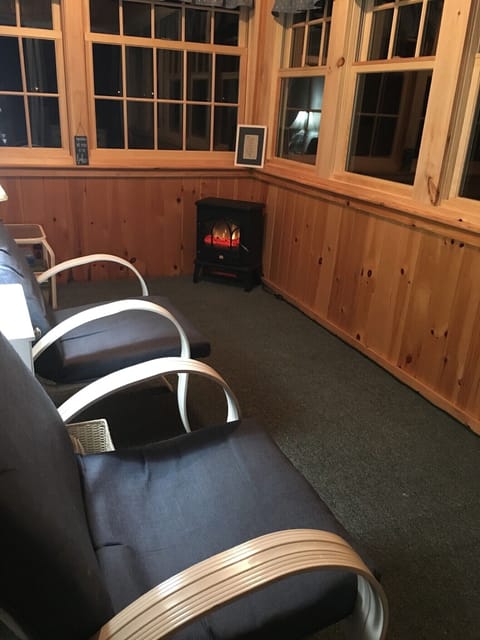 Pleasant porch with new windows & electric fireplace.