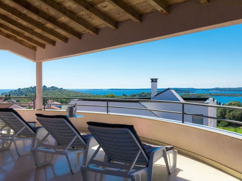 Sky, Property, Furniture, Water, Shade, Seaside Resort, Table, Outdoor Furniture, Chair, Wood