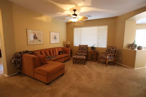 Comfortable chairs make standing easier in this well appointed Great room 