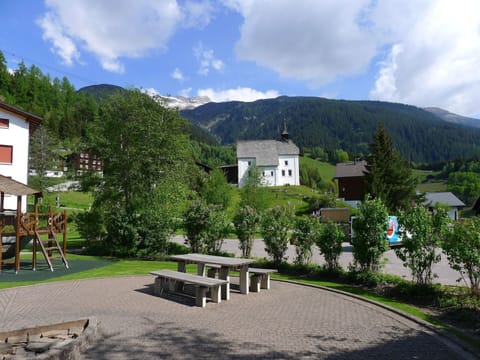 Cloud, Plant, Sky, Mountain, Building, Outdoor Bench, Tree, Natural Landscape, Window, Architecture