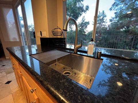 Granite Counters with Farmer Sink in the Kitchen