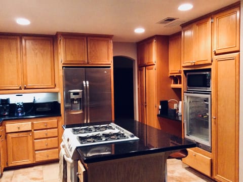 Granite Counters, Stainless Steel Gas Appliances and a Wine Fridge