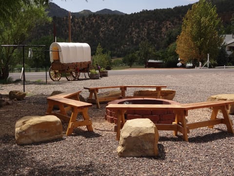 Fire pit with our Amish covered wagon in the background.