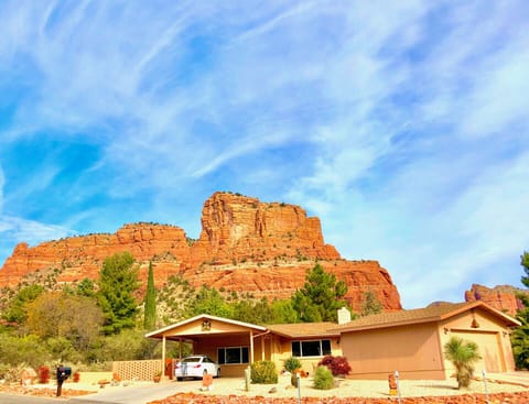 View of our home & garage with red rock overhead.