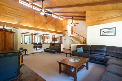 Very spacious living room with custom wood, opening into the dining room.