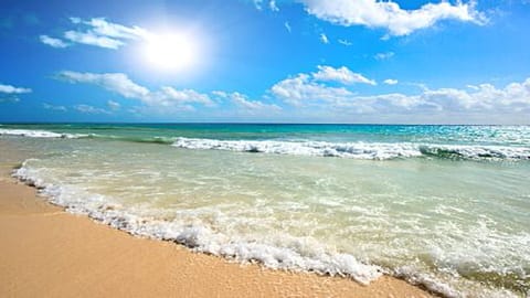 On the beach, sun loungers, beach towels