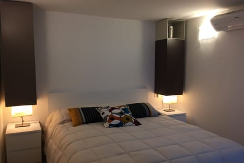 Second bedroom with a double bed located in the basement with a small window