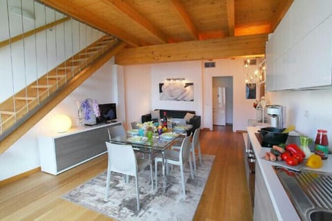 Living room with kitchen and dining area and staircase to first floor