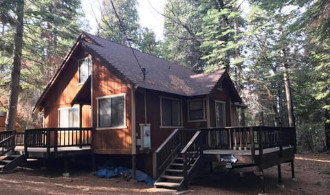 View from just off the road. Pines make deck great for relaxing or socializing