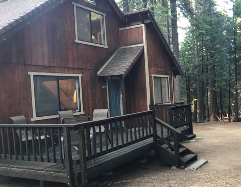 Patio set for a sunset dinner with view out to pines