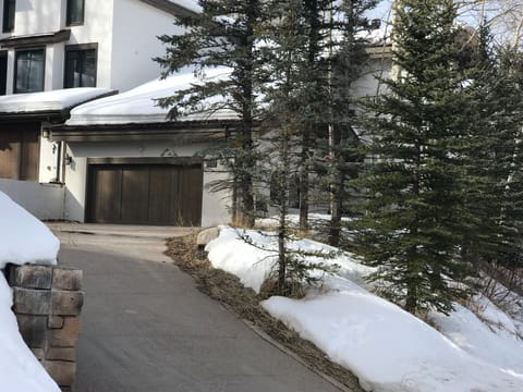 Exterior in winter. Heated driveway. Unit is the right-hand side of the duple