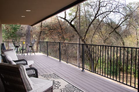 Large deck with plenty of patio furniture for entertaining