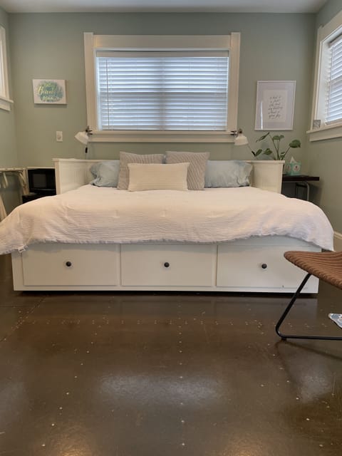 King sized bed with extra pillows and blankets in built in drawers