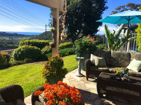 Flagstone Patio, Sofa, 2 Chairs & Ottomans with Ocean View
