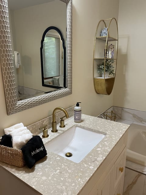 Attached master bath with his and hers sinks, shower, and 