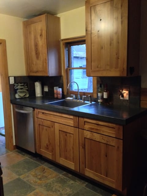 Kitchen with dishwasher and looks out to backyard