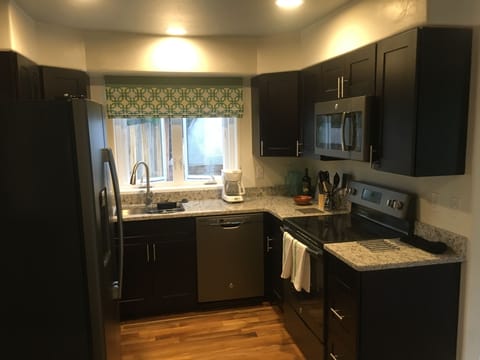 Kitchen with beautiful granite counter tops and stainless steel appliances
