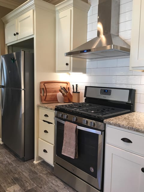 Stainless steel stove, refrigerator with ice maker and over the range hood!