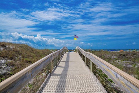 Walk along the scenic boardwalk leading to the beach at Phoenix V on the Alabama Gulf Coast to discover a new beach adventure
