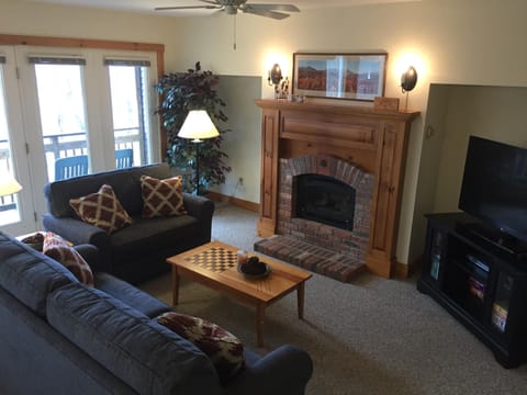 Living area with plenty of light, gas fireplace and new 49" flat screen TV.