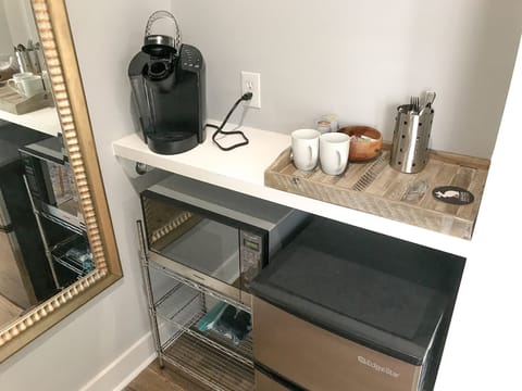 Fridge, microwave, coffee/tea maker, cookware/dishes/utensils