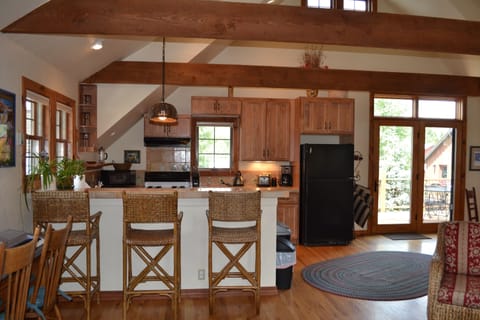 Fully equipped kitchen with seating at bar.
