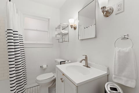 The private full bathroom features a tub/shower combo, a single vanity and toilet.
