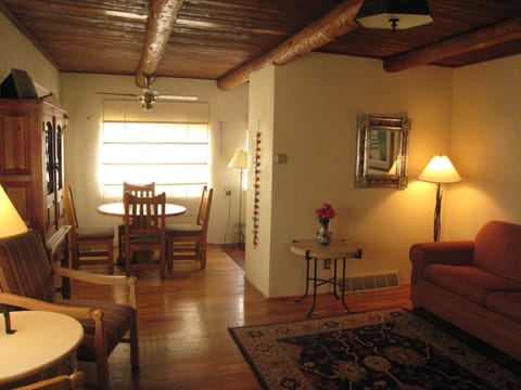 Living room view toward dining room with hand peeled "Viga" ceiling beams